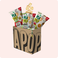 Pea a Pop snack packages with a cardboard box on a white background